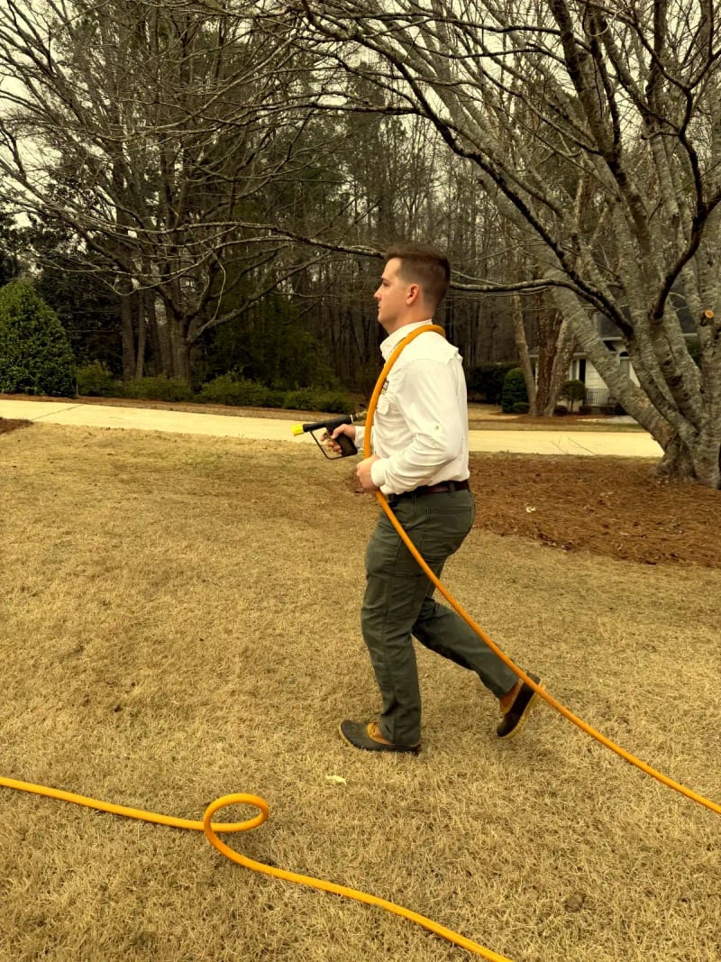 Attaboy technician applying targeted lawn treatment